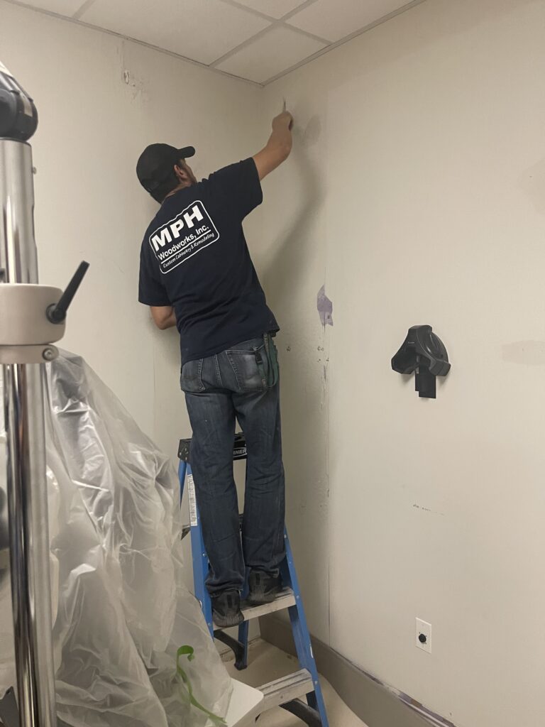 A worker on a step ladder a